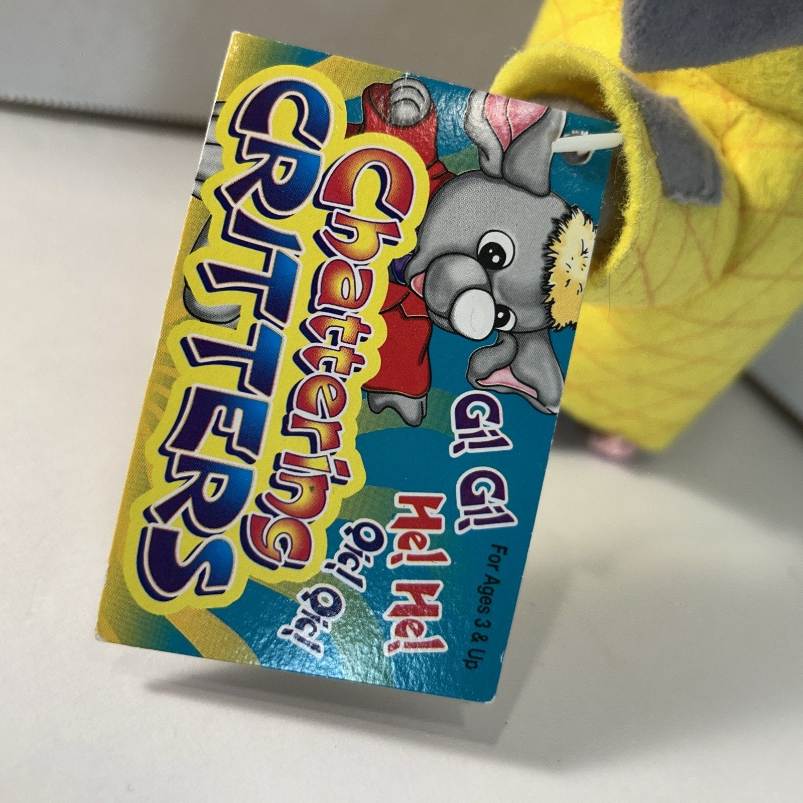 Chattering Critter Mouse Wearing a Yellow Shirt and a Black Hat
